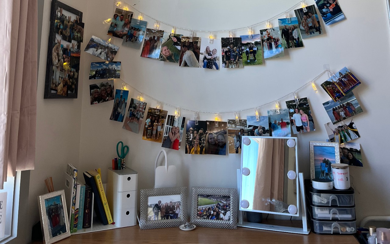 Dorm room desk decorated with pictures 